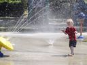 Axel Bousette, 3, runs through the spray at the splash pad at Walters Park in Dorval last month.