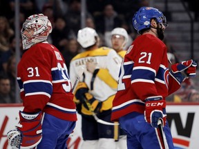 Canadiens goaltender Carey Price and defenceman David Schlemko look away as the Nashville Predators celebrate a goal last season. It was a familiar sight during a brutal year.