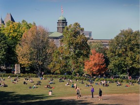 Students sit outside McGill University campus on October 12, 2016.
