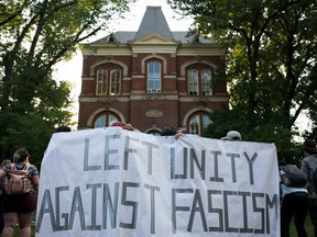 Activists demonstrate on the campus of The University of Virginia one year after a torchlit rally of racists marched on campus in Charlottesville, Va., on August 11, 2018.