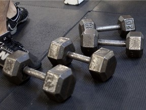 Free weights sit on the matt during a break at a gym.