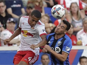 New York Red Bulls midfielder Tyler Adams, left, and Montreal Impact defender Daniel Lovitz compete for the ball during the first half of an MLS soccer game, Saturday, July 29, 2017, in Harrison, N.J.