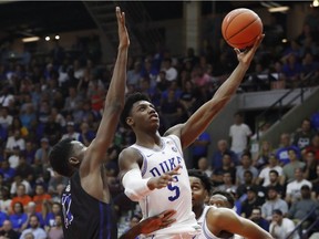 Blue Devils' R.J. Barrett puts up a shot against Ryerson Rams' Tanor Ngom during their exhibition basketball game in Mississauga, Ont., Wednesday night.