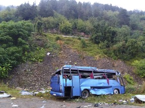 In this handout photo provided by the Bulgarian Interior Ministry, a view of a bus that crashed and overturned, near the town of Svoge, Saturday, Aug. 25, 2018.