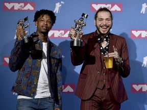 21 Savage, left, and Post Malone pose with their award for song of the year for "Rockstar" in the press room at the MTV Video Music Awards at Radio City Music Hall on Monday, Aug. 20, 2018, in New York.