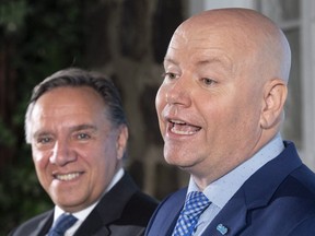 Former Montreal police inspector Ian Lafrenière announces his candidacy for the South Shore riding of Vachon as CAQ leader François Legault looks on in Longueuil, Que., on Aug. 21, 2018.