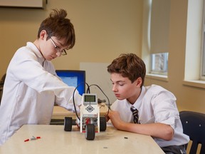 A couple of students at Centennial Academy in Montreal join forces to work on a project during a lunchtime robotics club.