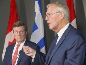 Bill Blair (right), federal minister of border security and organized crime reduction, and Mayor John Tory attend a press conference in Toronto on Friday, August 3, 2018.