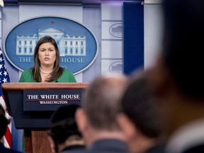 White House press secretary Sarah Huckabee Sanders reads a statement from President Donald Trump announcing that he will remove the security clearance from former CIA Director John Brennan during the daily press briefing at the White House, Wednesday, Aug. 15, 2018, in Washington. Sanders said the president will be reviewing the security clearances for a number of other former officials.