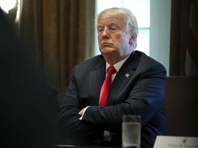 U.S. President Donald Trump listens during a meeting in the Cabinet Room of the White House in Washington, D.C., U.S., on Thursday, Aug. 16, 2018.