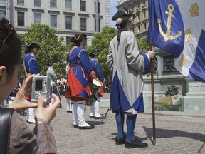 Soldiers in 17th-century uniforms of the Compagnie franche de la marine parade at Place d'Armes on May 20, 2007, near the monument to Paul Chomedy Sieur de Maisonneuve to mark the 365th anniversary of the founding of Montreal.