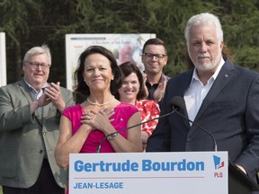 Quebec Liberal Leader Philippe Couillard announces that Jean-Lesage candidate Gertrude Bourdon, centre, would become health minister in a Liberal government, in Quebec City on Friday, August 24, 2018. Former Quebec Health Minister Gaetan Barrette, left, applauds as Bourdon puts her hands to her chest. Physician Brian Gore says whoever next serves as health minister needs to re-establish a healthier and more collaborative climate in our health-care institutions.