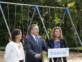 François Legault, with candidates Isabelle Charest, left, and Geneviève Hébert on Monday. There is a "very real possibility" the CAQ will win all the in the Eastern Townships, Legault said.