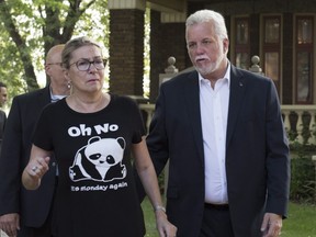 Quebec Liberal Leader Philippe Couillard and his wife Suzanne Pilote leave after an interview at a local radio station in Roberval, Que., Monday, August 27, 2018.