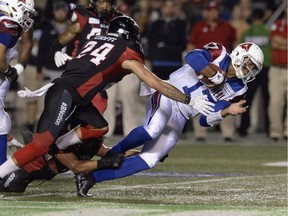 Alouettes quarterback Antonio Pipkin rushes for the first down as Redblacks defensive-back Anthony Cioffi defends during first half Friday night, August 31, 2018, in Ottawa.