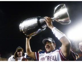 Montreal Alouettes quarterback Anthony Calvillo hoists the Grey Cup after their win over the Saskatchewan Roughriders in the CFL Grey Cup game on Nov. 28, 2010, in Edmonton.