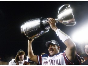 Montreal Alouettes quarterback Anthony Calvillo hoists the Grey Cup after their win over the Saskatchewan Roughriders in the CFL Grey Cup game Sunday November 28, 2010 in Edmonton. Calvillo has announced his retirement from the CFL team.