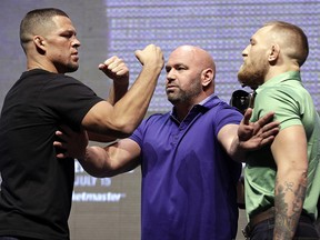 In this July 7, 2016, file photo, Dana White, centre, stands between Nate Diaz, left, and Conor McGregor during a news conference in Las Vegas for UFC 202.