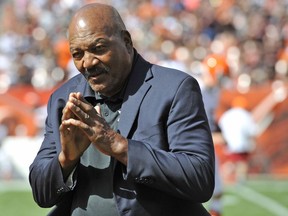 FILE - In this Sept. 21, 2014, file photo, former running back Jim Brown stands on the field during a halftime ceremony of an NFL football game between the Cleveland Browns and the Baltimore Ravens in Cleveland. Brown says he would never kneel during the national anthem. The 82-year-old Brown, who championed civil rights during his NFL career and became a social activist in retirement, said Tuesday night, Aug. 7. 2018, that he respects players' rights to do what they want but his preference is they would stand during "The Star-Spangled Banner."