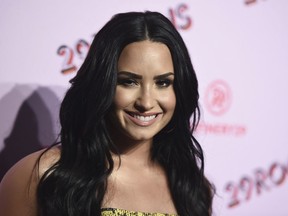 FILE - In this Dec. 6, 2017 file photo, Demi Lovato arrives at the West Coast debut of 29rooms at ROW DTLA in Los Angeles. Lovato has checked out of the hospital she was rushed to two weeks ago for a reported overdose. A person close to Lovato says she was released from Cedars-Sinai hospital in Los Angeles over the weekend. Lovato was hospitalized on July 24.