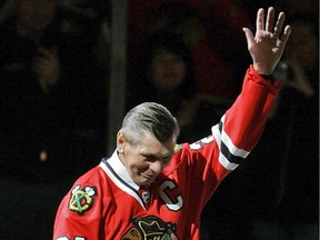 In this March 7, 2008, file photo, Chicago Blackhawks great Stan Mikita waves to fans as he is introduced before an NHL hockey game against the San Jose Sharks in Chicago. Mikita, who played for the Blackhawks for 22 seasons, becoming one of the franchise's most revered figures, has died.