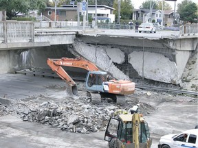 Workers clear the street Oct. 2, 2006, at de la Concorde overpass and Highway 19 two days after a section of the street collapsed onto the highway killing five people.