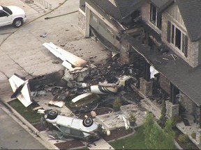 This frame from video shows the scene of a small plane that crashed into a house in Payson, Utah, on Monday, Aug 13, 2018. (John Wilson/KSL-TV/Deseret News via AP)