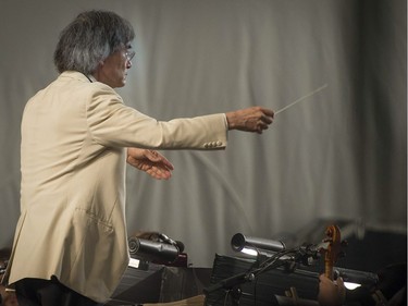 Kent Nagano conducts the OSM as they perform a free outdoor concert at the Olympic Park in Montreal, on Wednesday, Aug. 29, 2018. The orchestra kicks off its annual Classical Spree mini-festival with a show featuring circus artists from Cirque Eloize and recitations by Emmanuel Bilodeau.