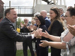 Coalition Avenir Québec Leader François Legault, left, is greeted by candidates as he launches his campaign, Thursday, Aug. 23, 2018 in Quebec City.