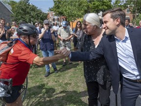 Québec solidaire's Manon Massé and Gabriel Nadeau-Dubois greet supporters in Montreal on Thursday, August 23, 2018. Massé clarified Friday that the party does not view English as an official language of Quebec.