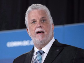 Quebec Premier Philippe Couillard delivers a luncheon speech in Montreal in June. There's speculation that Couillard may trigger Quebec's general election campaign several days earlier than expected.