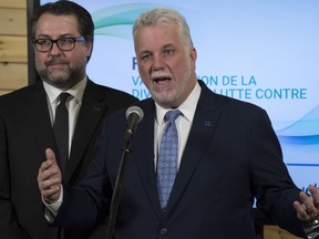 Quebec Immigration, Diversity and Inclusiveness Minister David Heurtel and Premier Philippe Couillard attend a news conference in this 2017 file photo: The province is offering a limited number of "startup visas" for non-French-speaking tech entrepreneurs.