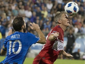 Chicago Fire's Bastian Schweinsteiger heads the ball as Montreal Impact's Ignacio Piatti defends during second half MLS action in Montreal on Saturday, Aug. 18, 2018.