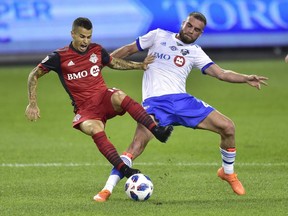 Toronto FC forward Sebastian Giovinco (10) is fouled by Montreal Impact defender Rudy Camacho (4) in Toronto on Aug. 25, 2018.