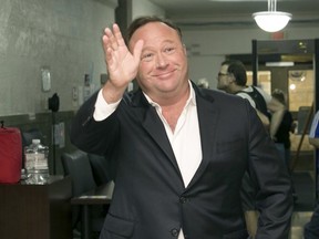 In this Wednesday, April 19, 2017, file photo, Alex Jones arrives for a child custody trial at the Heman Marion Sweatt Travis County Courthouse in Austin, Texas.