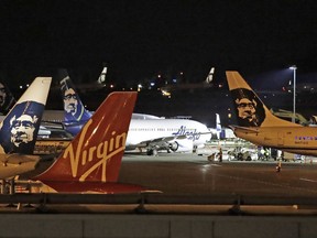 Alaska Airlines and other planes sit on the tarmac at Sea-Tac International Airport Friday evening, Aug. 10, 2018, in Seattle, Wash.