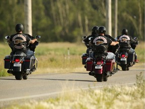 Hells Angels members ride along 84 Street SE towards the Hells Angels' clubhouse on Friday, July 21, 2017 in Calgary.