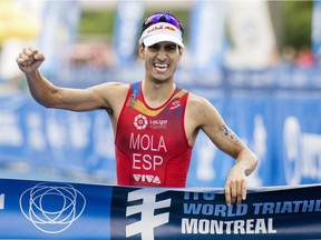 Mario Mola of Spain celebrates after winning the ITU World Triathlon Series race in Montreal, Sunday, August 26, 2018.