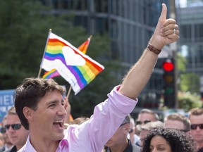 Prime Minister Justin Trudeau salutes the crowd as he marches in the pride parade in Montreal on Sunday, August 19, 2018. "Although, given the occasion, Trudeau was primarily referencing the LGBTQ community, his rebuke of tolerance should be extended to other groups," Myrna Lashley writes.