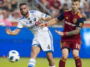 Real Salt Lake midfielder Albert Rusnak (11) makes contact with Montreal Impact defender Rudy Camacho (4) in MLS soccer game action in Sandy, Utah, Saturday, Aug. 11, 2018.