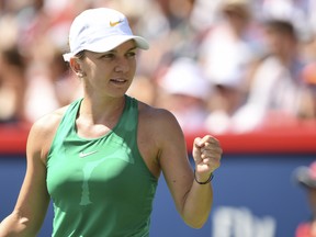 MONTREAL, QC - AUGUST 11:  Simona Halep of Romania celebrates her 6-4, 6-1 victory against Ashleigh Barty of Australia during day six of the Rogers Cup at IGA Stadium on August 11, 2018 in Montreal, Quebec, Canada.  (Photo by Minas Panagiotakis/Getty Images)