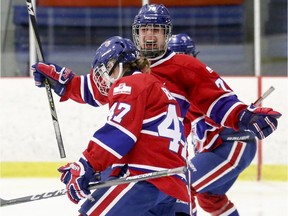 Les Canadiennes' Tracy-Ann Lavigne, rear, celebrates with goa-scorer Emmanuelle Blais during third period of Canadian Women's Hockey League playoff game against the Markham Thunder in Montreal on March 16, 2018.