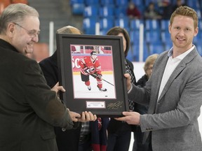 Florida Panthers' Mike Matheson, right, is honoured by Pointe Claire Mayor Morris Trudeau prior to a game at Bob Birnie Arena on March 29, 2017.