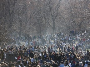 A cloud of smoke wafts over a crowd celebrating 4/20 at Mont-Royal Park in Montreal, Wednesday April 20, 2016. The Coalition Avenir Québec doesn't want to see scenes like this in Quebec, and will move to ban cannabis smoking in public as well as raise the legal toking age to 21 -- if elected on Oct. 1.