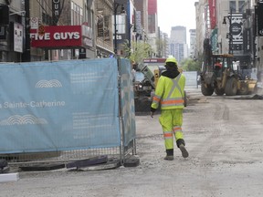 Work crews on Ste-Catherine St. near Robert-Bourassa Blvd. in May 2018.