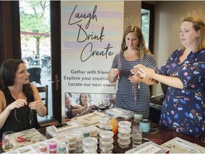 Elissa Shorrock (left) looks on as Cynthia Mass (centre) and Melanie Garon-Duong demonstrate how to make a piece of jewelry during a LaughDrinkCreate event held recently at Rockaberry in Kirkland.