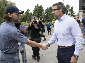 Montreal Canadiens general manager Marc Bergevin, centre, shakes hands with Jonathan Drouin during Drouin's benefit golf tournament in Terrebonne on Thursday September 6, 2018. In background is Habs captain Max Pacioretty with his agent Allan Walsh.   (Pierre Obendrauf / MONTREAL GAZETTE) ORG XMIT: 61326 - 1090