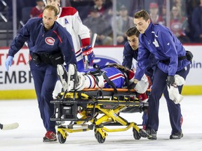 Canadiens and Maple Leafs training staff wheel Canadiens Jarret Tyszka off the ice on a stretcher after he was driven headfirst into the end board by Maple Leafs Hudson Elynuik during first period of Rookie Challenge game in Laval, north of Montreal Sunday September 9, 2018.  Elynuik was thrown out of the game.