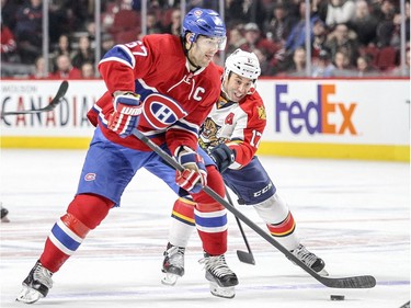 Pacioretty takes a shot while being pursued by Florida Panthers’ Derek MacKenzie in Montreal on April 5, 2016.