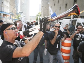 STM maintenance workers make noise outside the company headquarters on de la Gauchetière St., to protest lagging contract talks on Thursday.